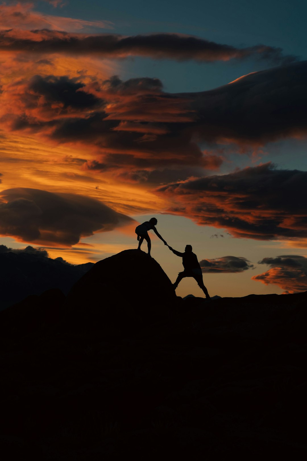 service-04 a-couple-of-people-holding-hands-on-top-of-a-hill-hynxiq1np0e